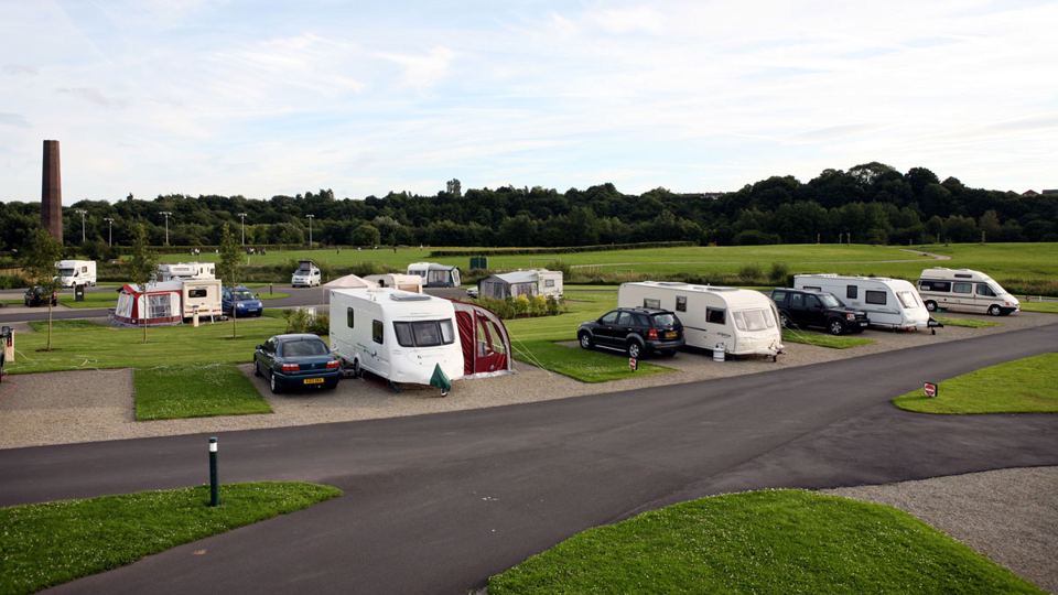 Pitches with the mill chimney behind