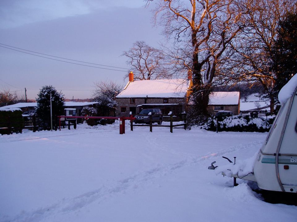 Caravan and farm in the snow