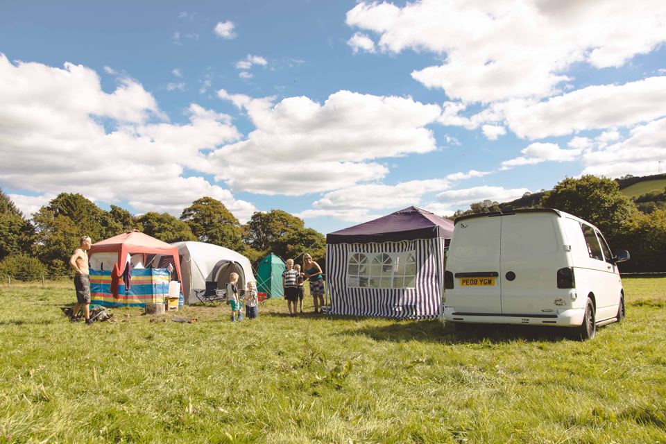 Tents and a van on the field