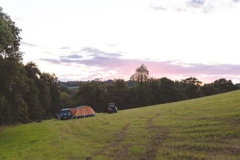 Tents on the sloping field at dusk
