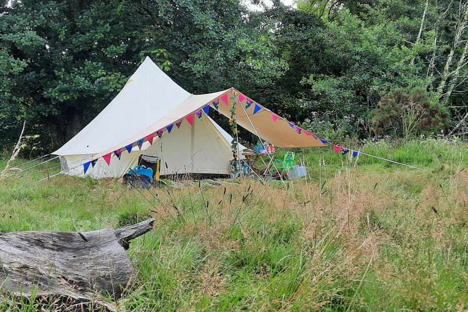 Bell tent with bunting in the trees