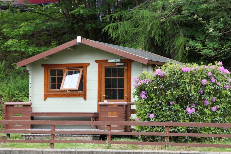 Wooden cabin with rhododendrons