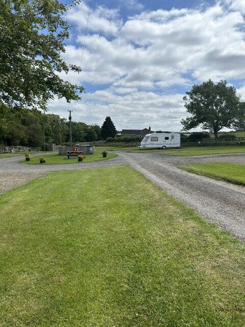 Gravel roadway and grass pitches