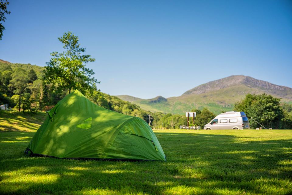 Tent on grass with mountain view