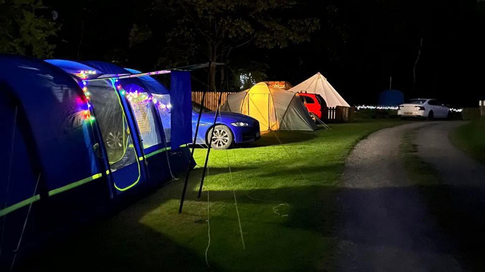 Tents and awning lights at night