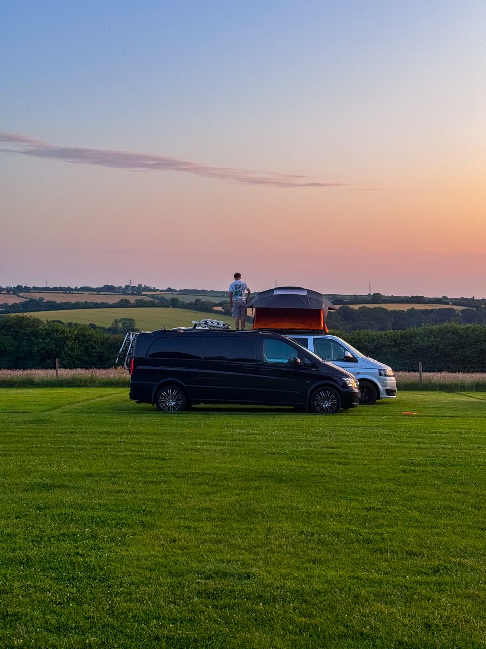 Campervans on the pitch at sunset