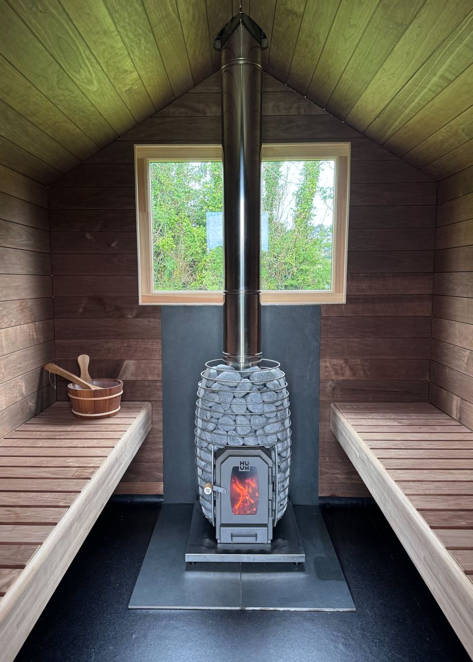 Inside the sauna with wood stove