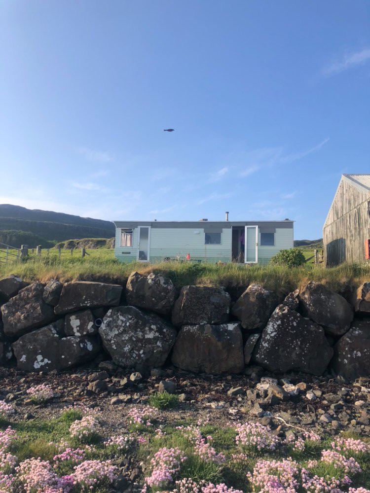 Caravan behind a stone wall