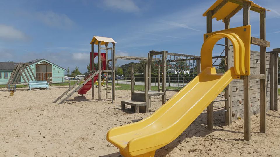 Play area with slide and climbing frame