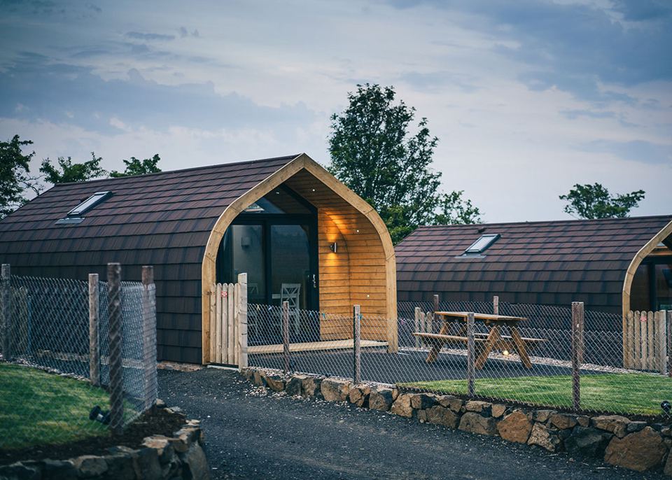 Row of cabins with fenced gardens