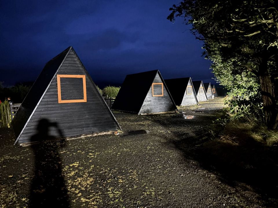 Row of A-frame pods at night