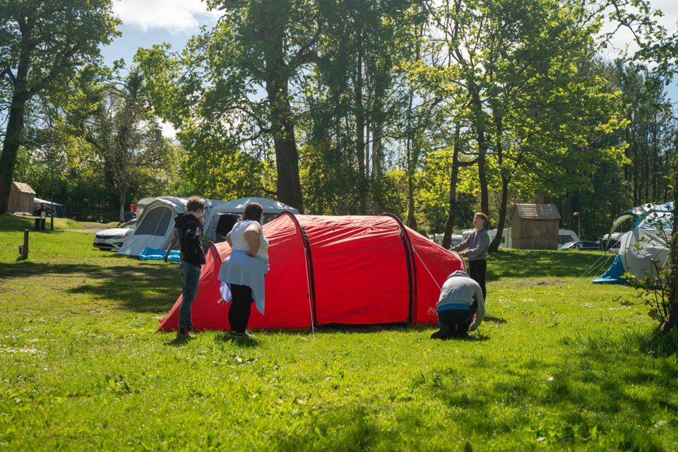 Pitching a tent on the grass