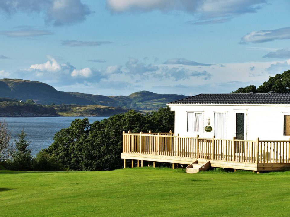 Holiday home with deck above the loch