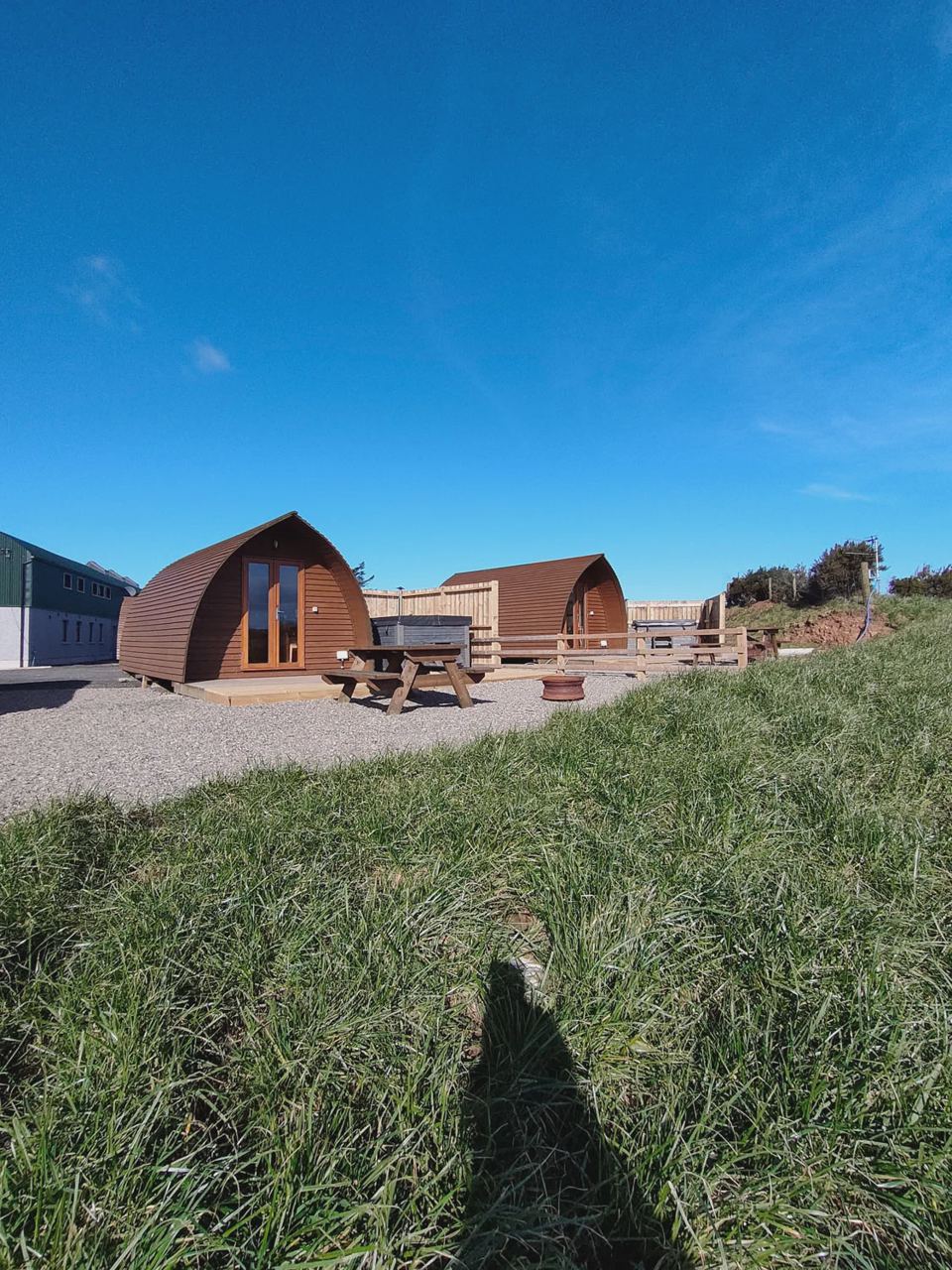 Row of wigwams across the grass