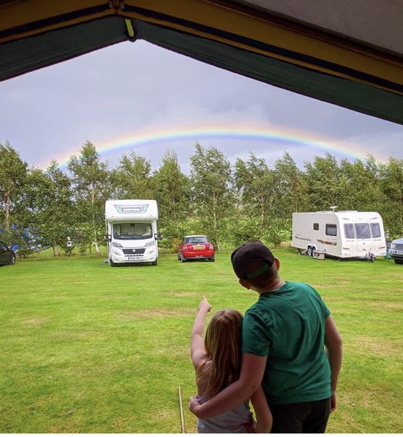 Motorhomes and caravan on grass