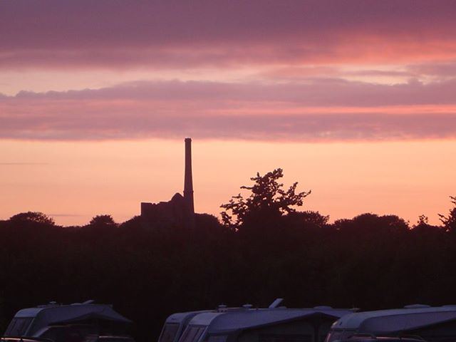 Sunset over the mine chimney and caravans