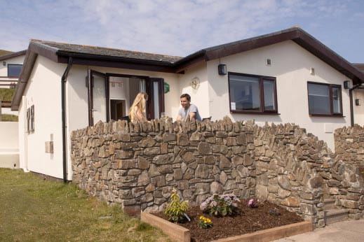 Lodge behind a stone wall