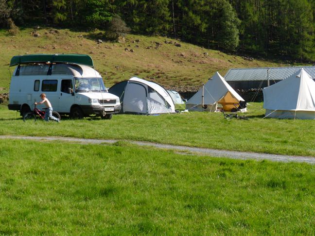 Campervan and tents in the field