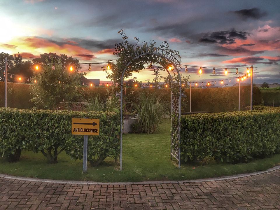 Lit barbecue area at dusk