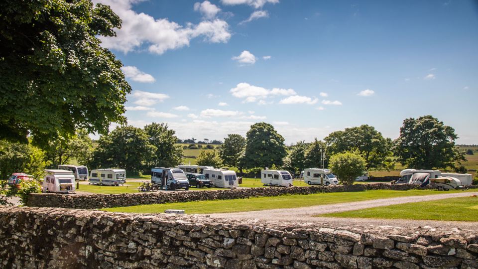 Touring pitches by stone wall