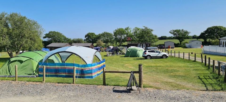 Tent pitches beside a gravel track