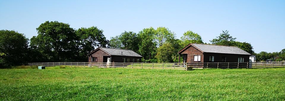 Two lodges in a grass field