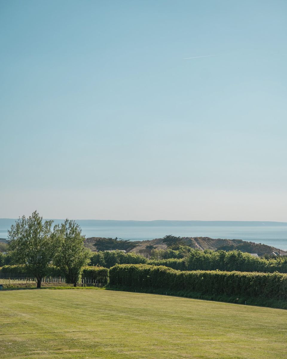 Field with sea view beyond the hedge
