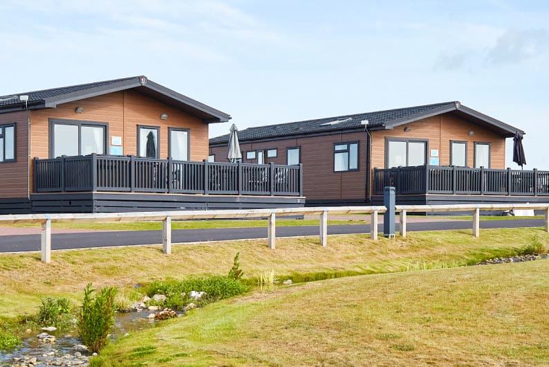 Lodges by the grass verge