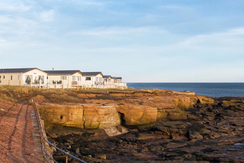 Caravans above the rocky shore