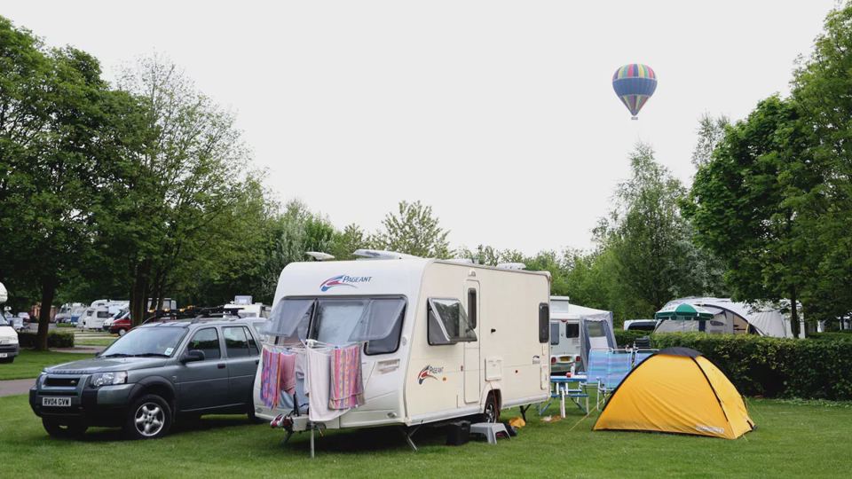 Caravan and tent on grass