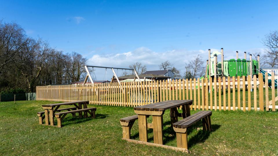 Play area with picnic tables