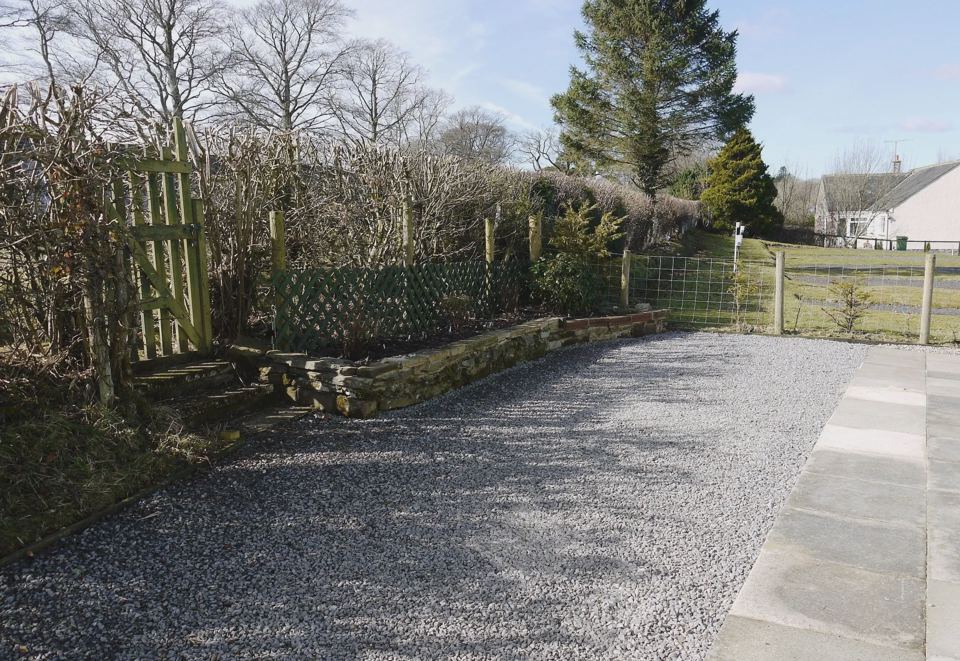 Gravel pitch beside garden fence