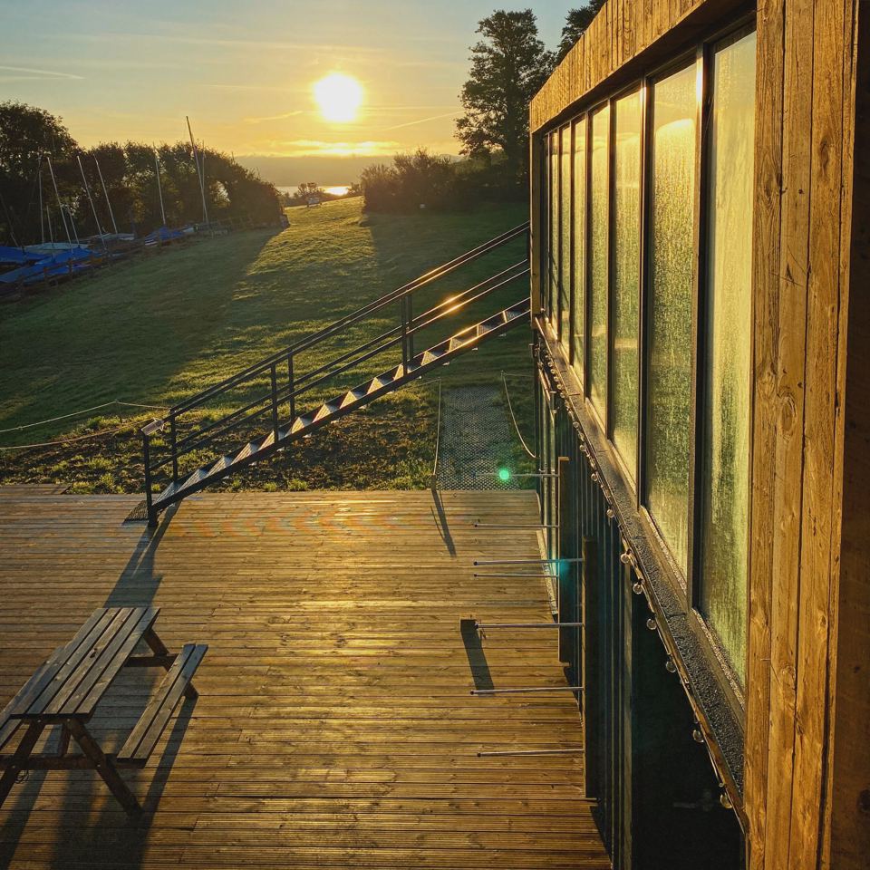 Glass-fronted cabin at sunset