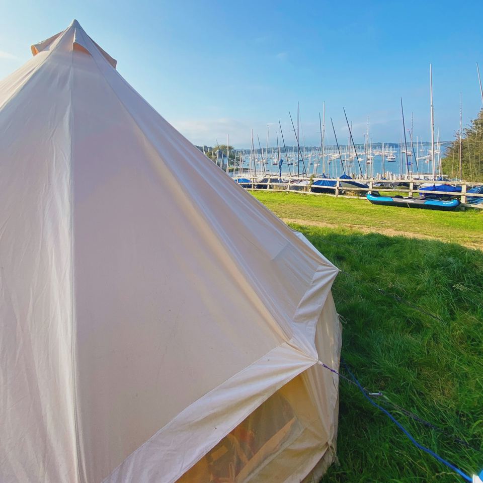 Bell tent with boats in the marina