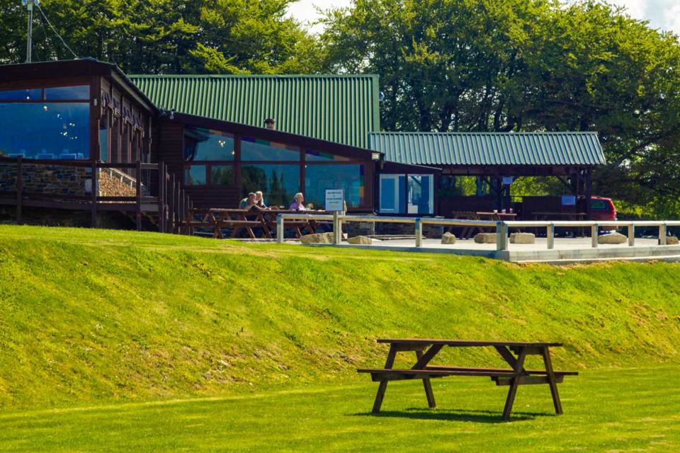 Building with decking and picnic benches