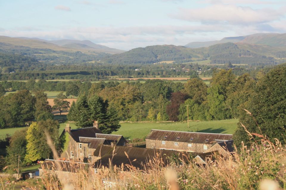 Farm buildings below the hills