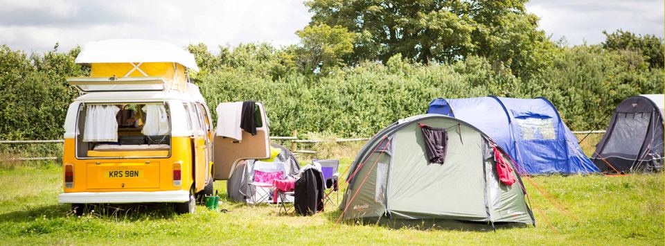 Campervan and tent on the grass