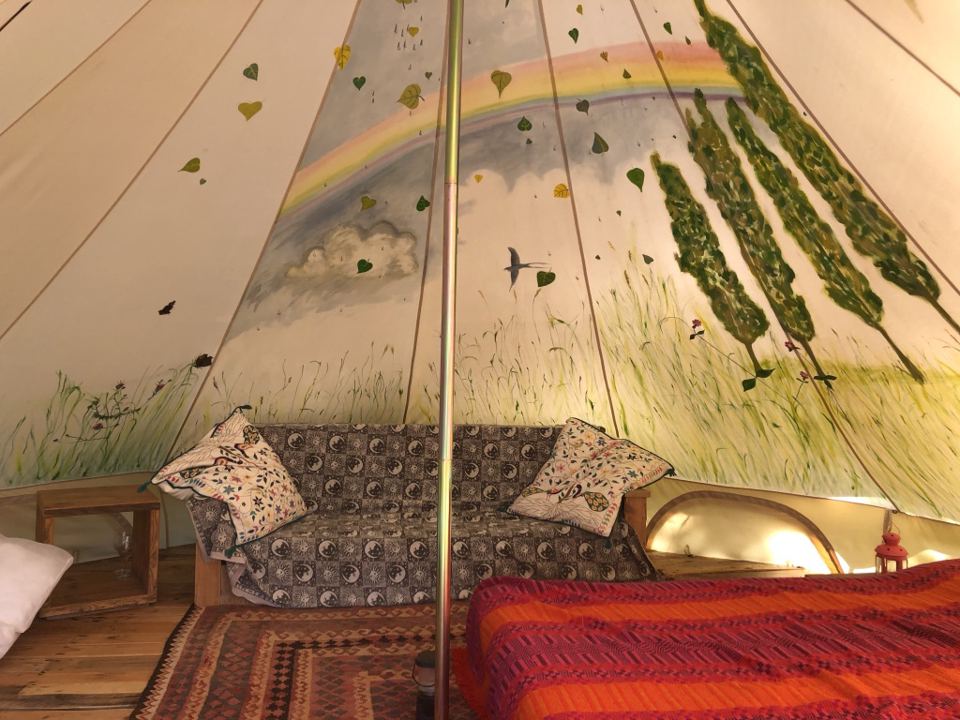 Inside a painted bell tent