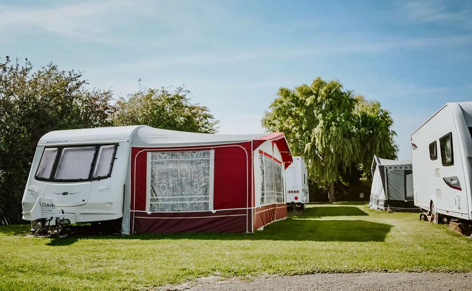 Caravan with awning on grass