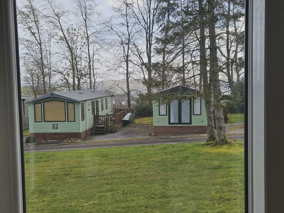 Green lodge seen through window