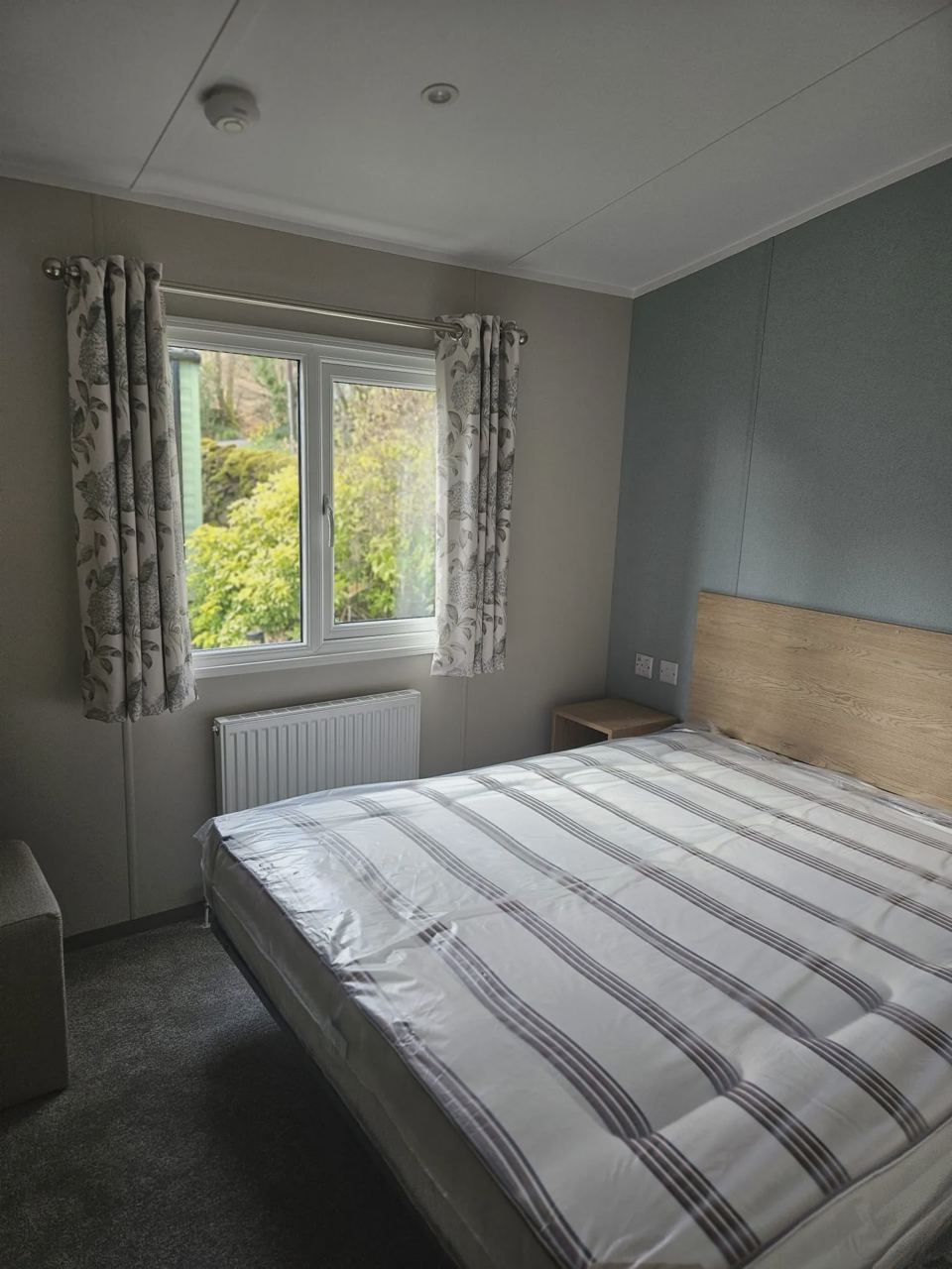Double bedroom with plaid curtains