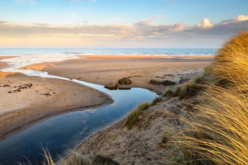 Stream through the dunes to the sea