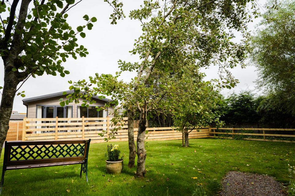 Lodge in the garden behind the fence