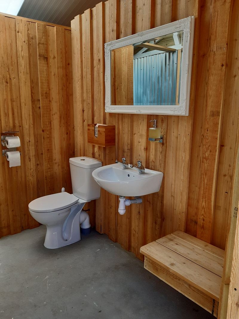 Shower and basin in a timber cubicle