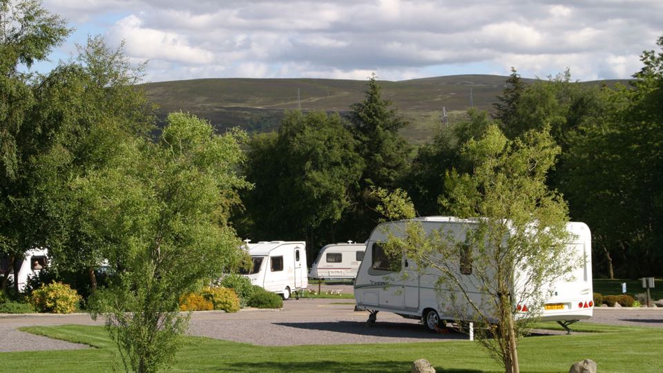 Caravan pitches below the hills