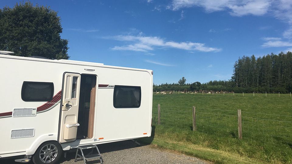 Caravan beside open field