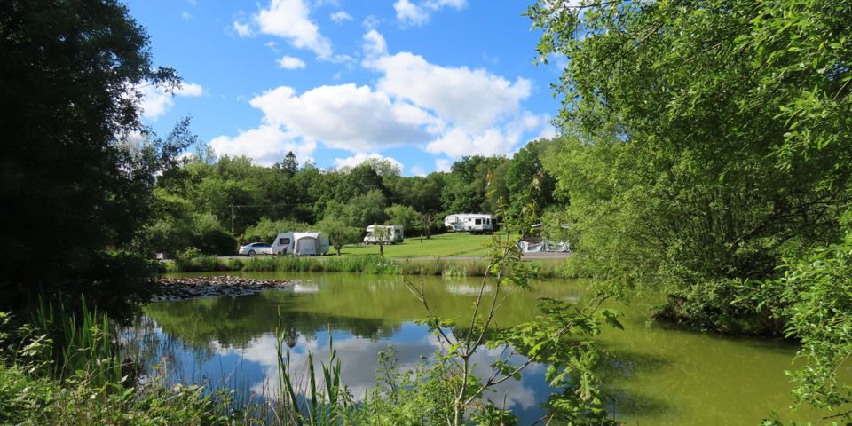 Pond with vans beyond