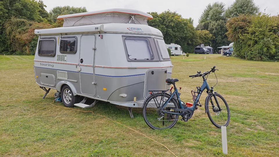 Small caravan and bike on grass