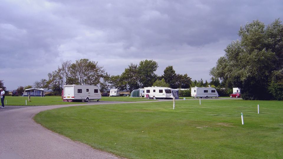 Grass pitches and curving road