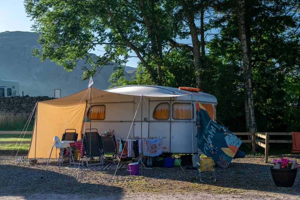Awning and caravan under a tree